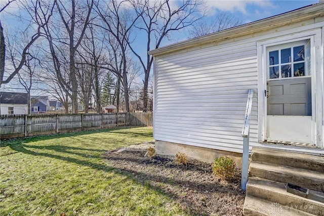 view of yard with entry steps and fence