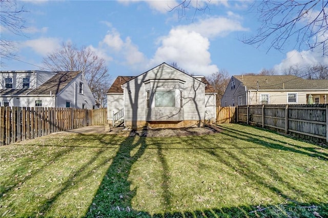 view of yard featuring entry steps and a fenced backyard