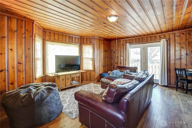 living area with wooden walls, wooden ceiling, and hardwood / wood-style flooring