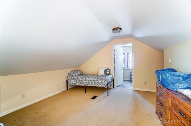 bedroom featuring baseboards, light carpet, and vaulted ceiling