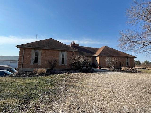 view of front facade featuring a chimney