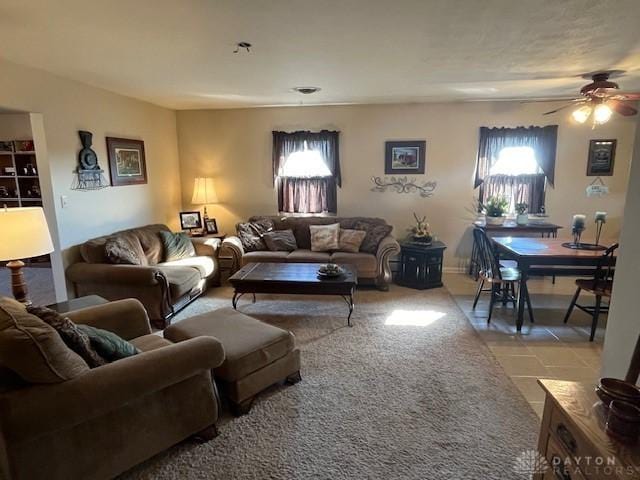 carpeted living room with ceiling fan