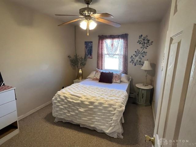 carpeted bedroom with baseboards and ceiling fan