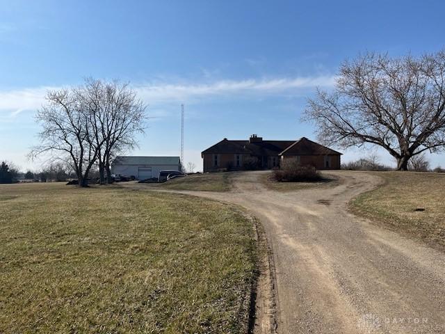 view of front of home with a front yard and driveway