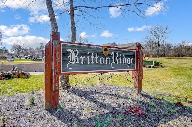 community sign featuring a lawn