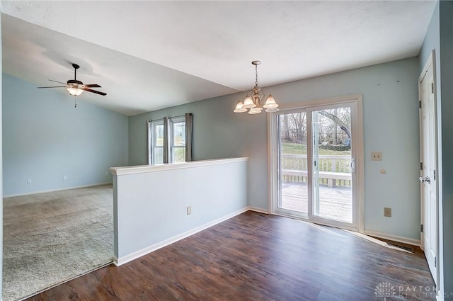 unfurnished room featuring plenty of natural light, baseboards, lofted ceiling, and wood finished floors