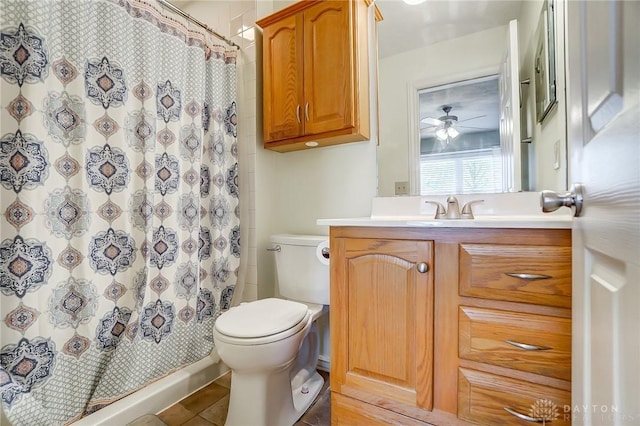 bathroom with toilet, vanity, a shower with curtain, and a ceiling fan