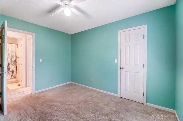 unfurnished bedroom with baseboards, carpet floors, and a ceiling fan