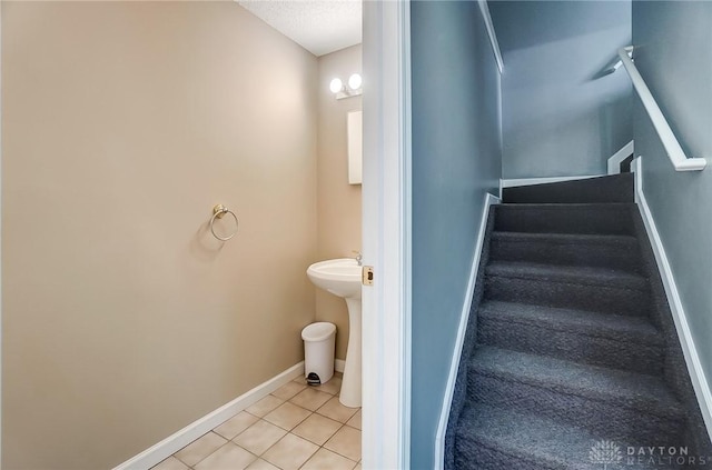 bathroom featuring tile patterned flooring and baseboards