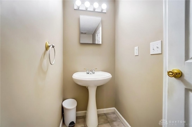 bathroom featuring baseboards and tile patterned flooring