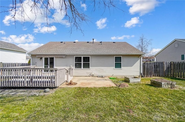 rear view of property with a patio, a lawn, a vegetable garden, and fence