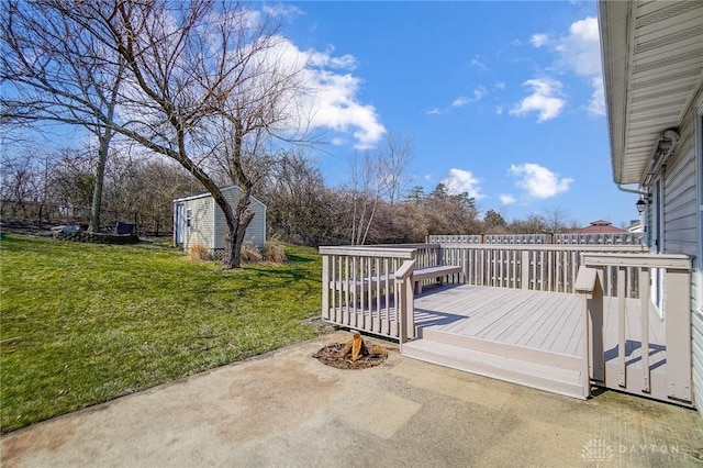 deck featuring a lawn, a patio, a storage shed, and an outdoor structure