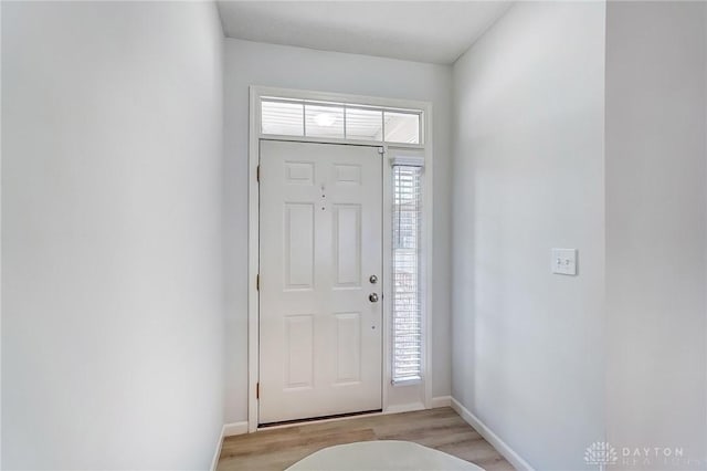 foyer featuring baseboards and light wood-style floors