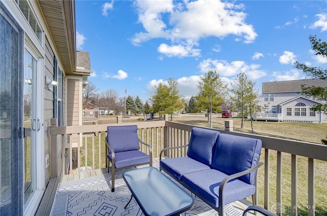 deck featuring a yard and a residential view