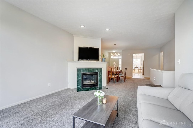 carpeted living area with recessed lighting, a tile fireplace, and baseboards