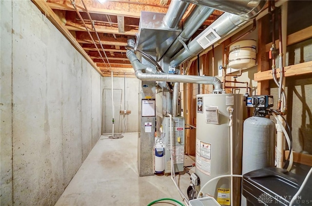 utility room featuring gas water heater and visible vents