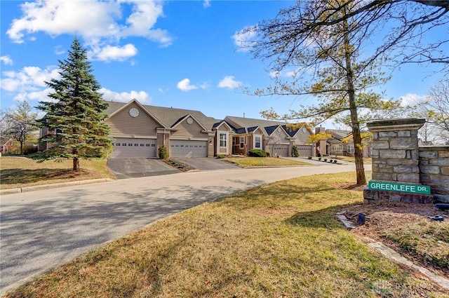 view of front of property with an attached garage, a residential view, and driveway