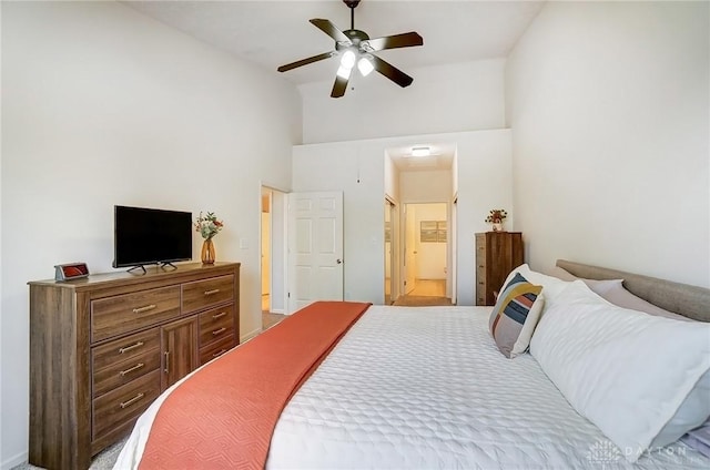 bedroom featuring ceiling fan, a high ceiling, and connected bathroom