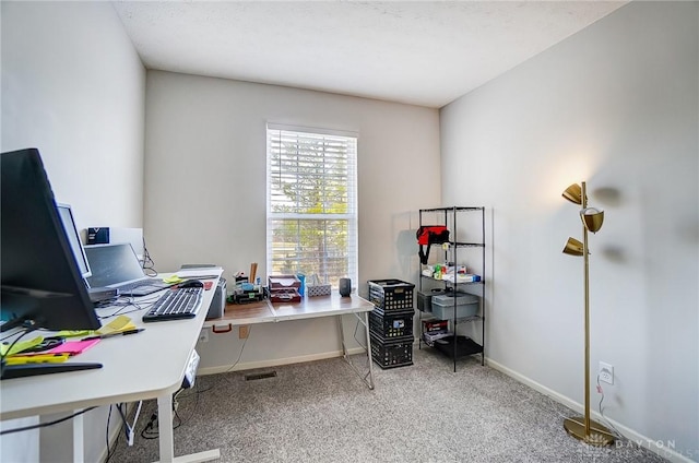 carpeted office featuring baseboards