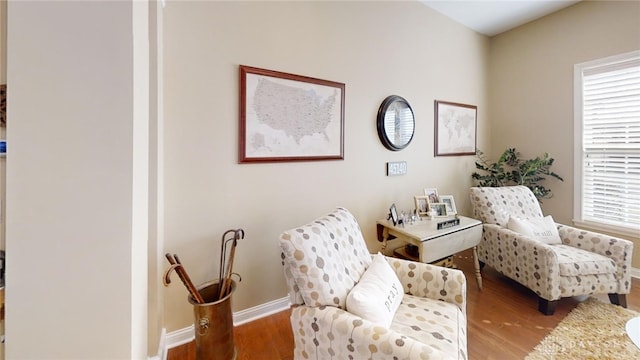 living area featuring baseboards and wood finished floors