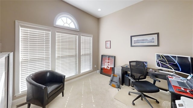 office space with vaulted ceiling, carpet, and visible vents