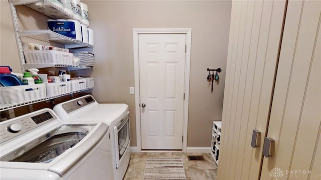 laundry area featuring washing machine and clothes dryer, laundry area, baseboards, and visible vents