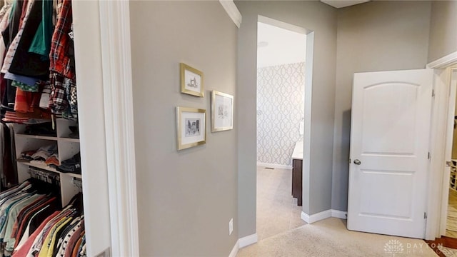 corridor with light colored carpet and baseboards