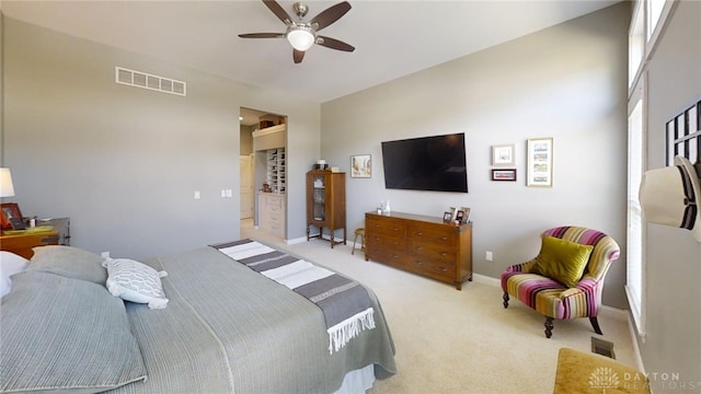 carpeted bedroom featuring visible vents, baseboards, and ceiling fan