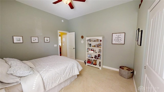 bedroom with light carpet, ceiling fan, and baseboards