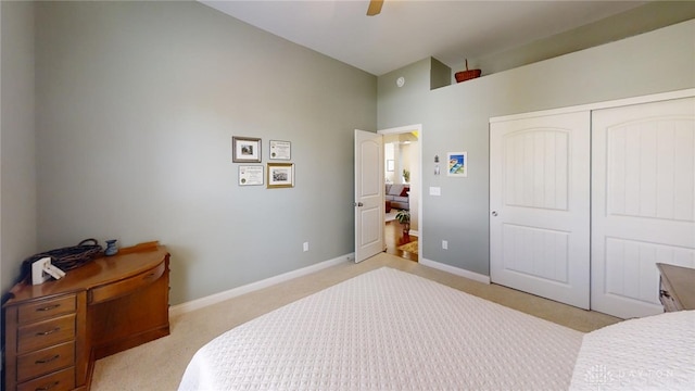 bedroom featuring a closet, baseboards, and light colored carpet