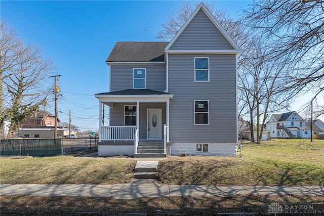 view of front of home with a porch, a shingled roof, a front yard, and fence