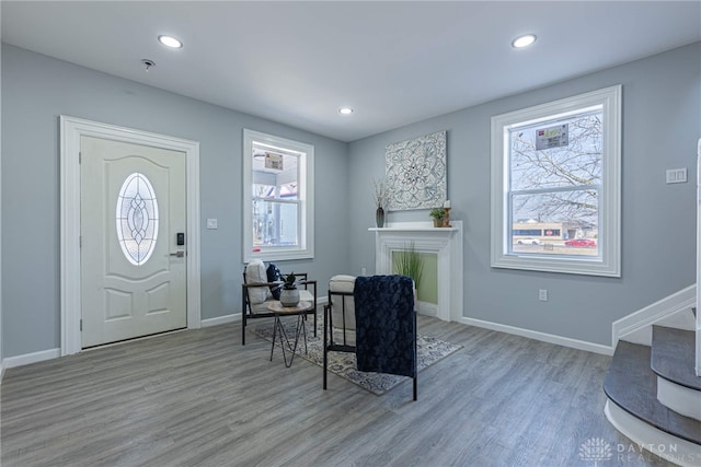 foyer with recessed lighting, wood finished floors, and baseboards