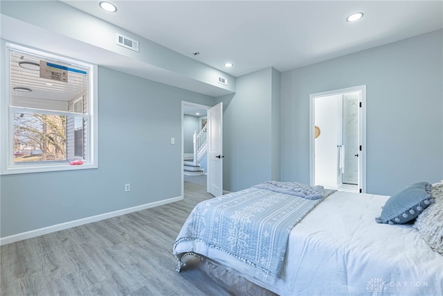 bedroom featuring recessed lighting, visible vents, baseboards, and wood finished floors