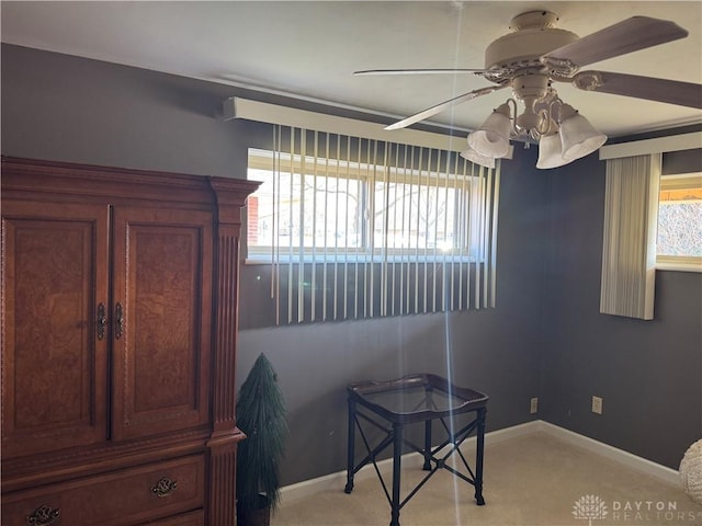 interior space featuring ceiling fan and baseboards