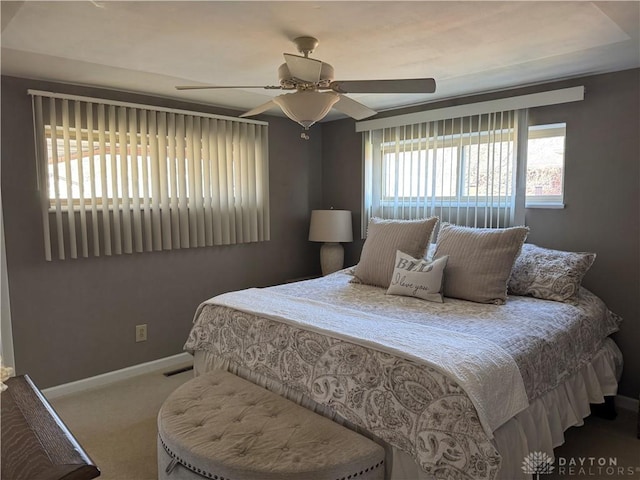 bedroom with visible vents, baseboards, ceiling fan, and carpet flooring