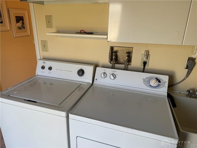 clothes washing area with washer and dryer and laundry area