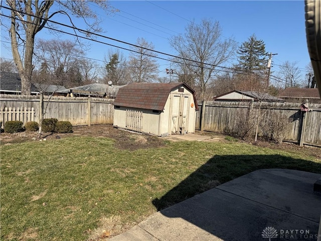 view of yard featuring a fenced backyard, a patio, a storage shed, and an outdoor structure