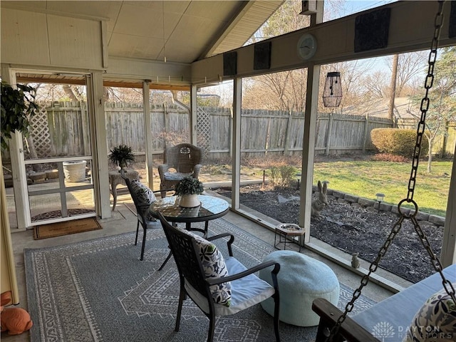 unfurnished sunroom featuring a healthy amount of sunlight and vaulted ceiling