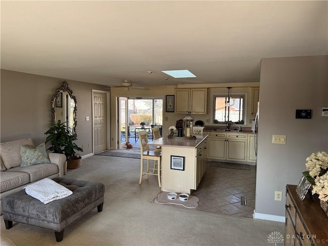 kitchen featuring a kitchen breakfast bar, a healthy amount of sunlight, open floor plan, and a sink