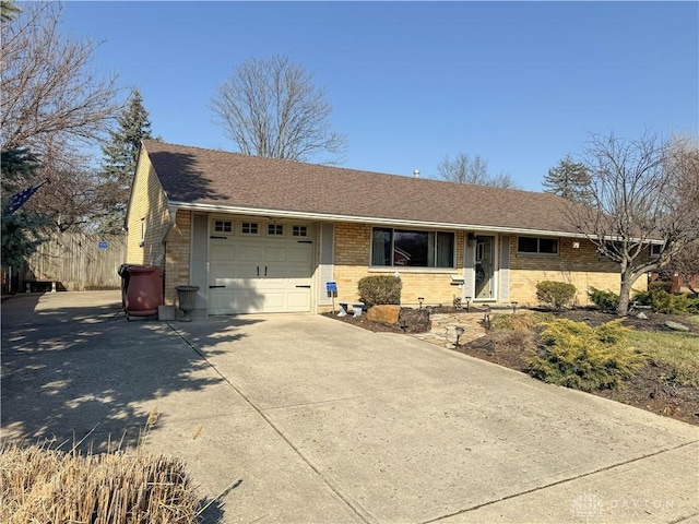 ranch-style home with brick siding, a garage, driveway, and a shingled roof