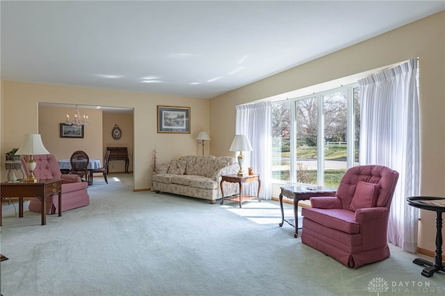 carpeted living room with a chandelier