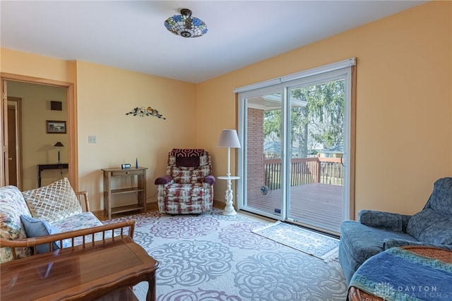 living area with baseboards and visible vents