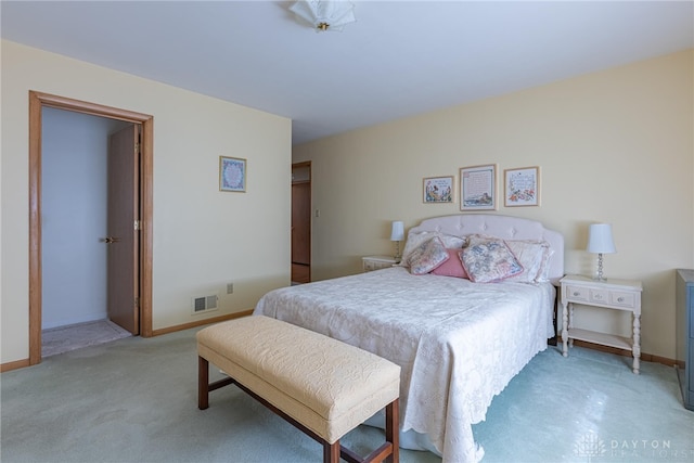 bedroom with light carpet, visible vents, and baseboards