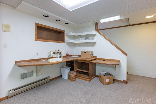 carpeted office space featuring visible vents, a baseboard heating unit, baseboards, and a drop ceiling