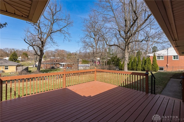 wooden deck with a residential view and a lawn