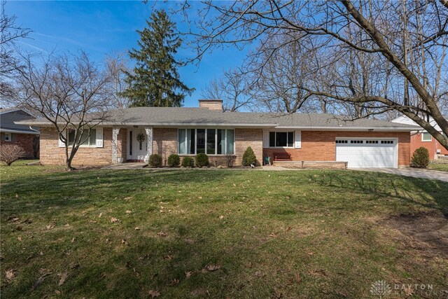 single story home featuring brick siding, an attached garage, a chimney, and a front yard