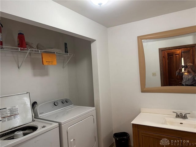 laundry area featuring a sink, washing machine and dryer, and laundry area