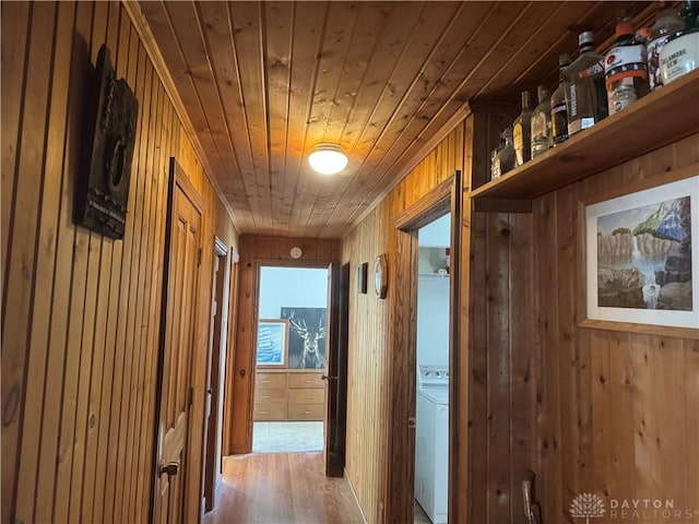 corridor with wooden ceiling, wooden walls, and wood finished floors