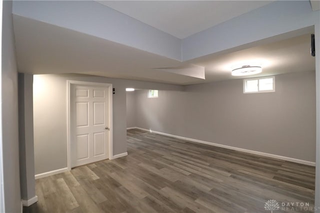 below grade area with wood finished floors and baseboards