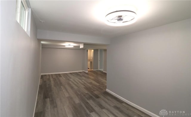 interior space featuring baseboards and wood finished floors